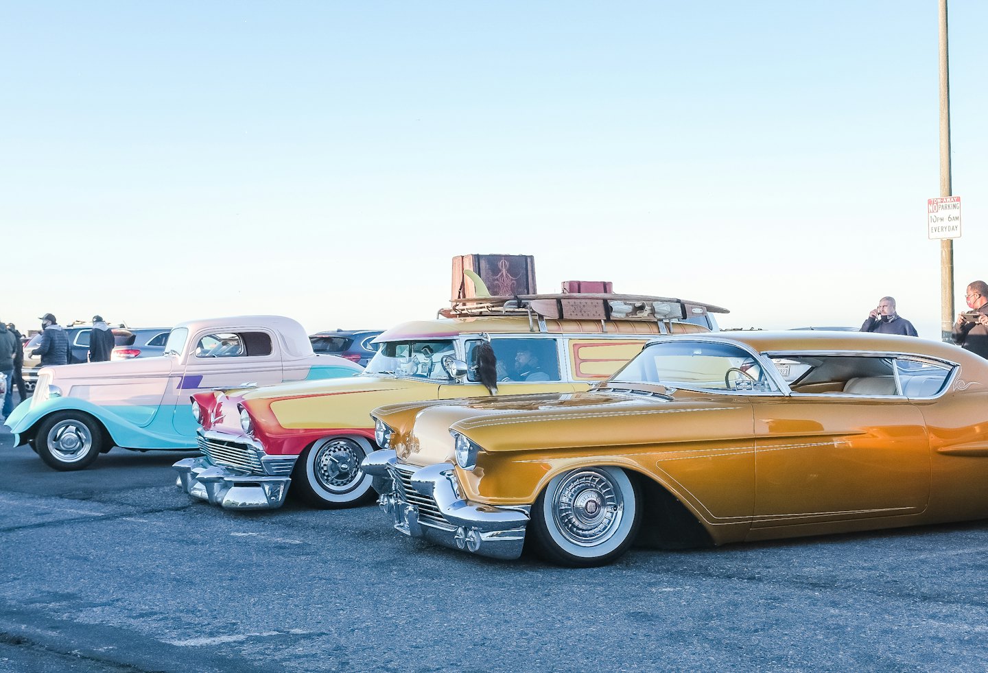Custom classic cars parked outdoors at a public show.